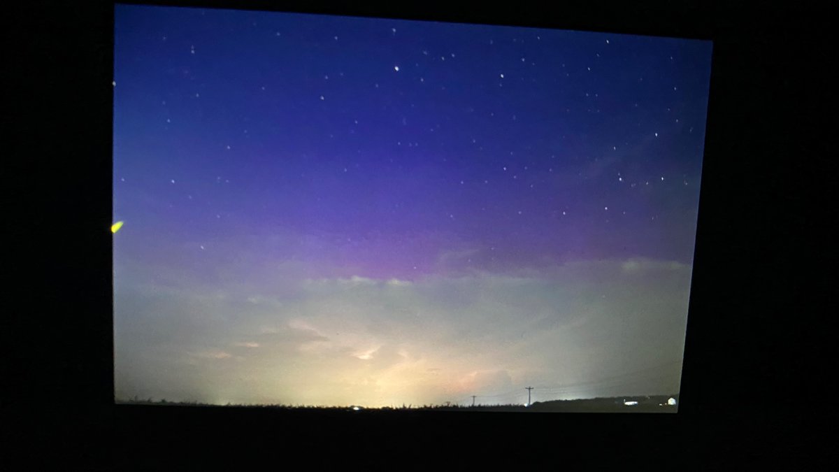 EthanB86419472's tweet photo. PURPLE visible above continuing thunderstorms in northern IN right now! #inwx #indiana #wxtwitter #aurora #solarstorm https://t.co/7K79ppRDY5