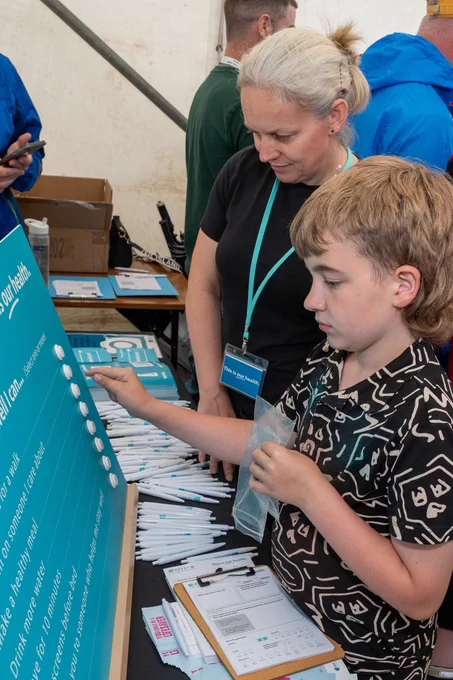 A boy tries out the 'This is our health' choice board.