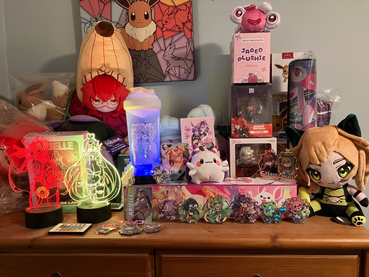 Rickbrian_'s tweet photo. @YomiQuinnley @rokotimeout I actually just got finished readjusting my setup for better streaming quality. Also, merch shelf :3 can you identify all the vtubers? https://t.co/80a4KL1I00