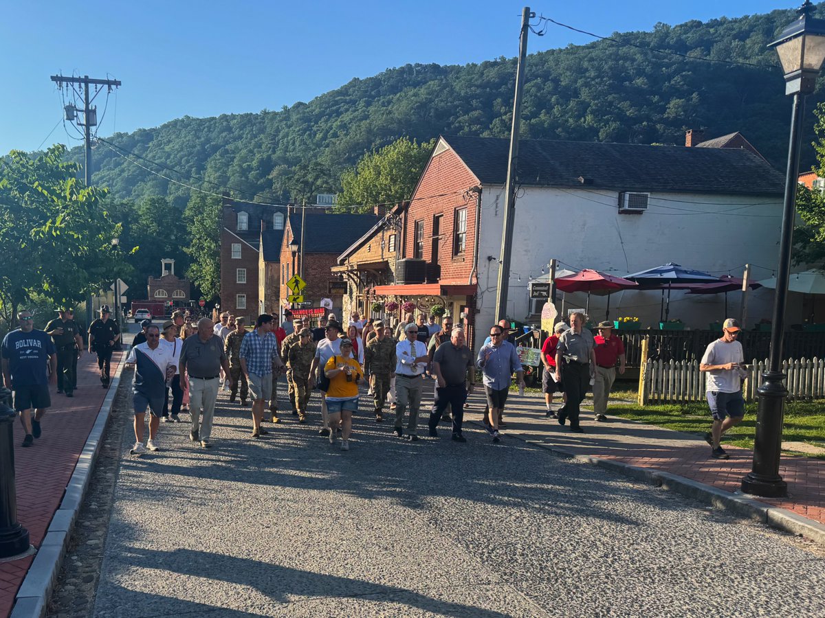 wvgovernor's tweet photo. This morning in Harpers Ferry, crowds began to gather as Governor Morrisey joined residents and local officials for a walk through the historic town, the first stop on a statewide Fourth of July tour celebrating America's 250th anniversary. https://t.co/nNITG0VQhl
