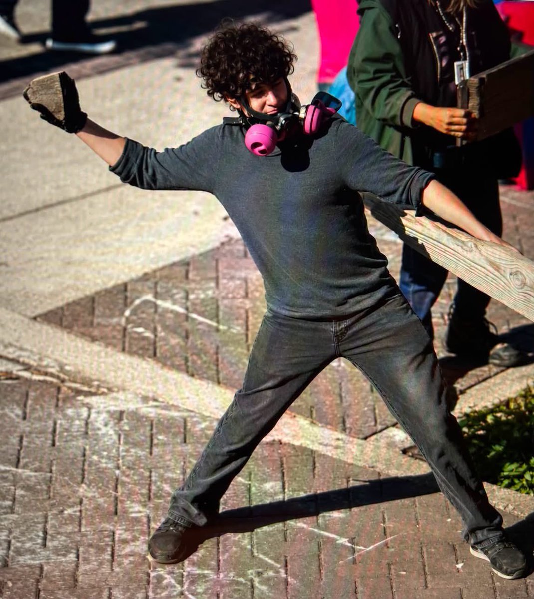 GOP_is_Gutless's tweet photo. Another Democrat  recruit ANTIFA Thug Gets Jail Time!

The specific incident took place on June 14, 2025, right outside the Immigration and Customs Enforcement (ICE) building.  What began as a standard demonstration quickly deteriorated into a chaotic and highly destructive riot.

Amidst the screaming crowd, Robert Jacob Hoopes actively integrated himself into the most aggressive faction of the riot and documents reveal that Hoopes targeted a specific ICE Enforcement and Removal Operations officer standing guard.

Hoopes picked up a large, heavy rock from the surrounding pavement and forcefully hurled it at the federal officer. The rock struck the uniformed ICE official directly in the head with immense, localized force.

The severe impact caused a deep and immediate laceration directly over the law enforcement officer's eye. Blood from the wound began flowing heavily down the officer's face, completely obstructing his vision.

The injured federal official required immediate emergency medical transportation to a nearby local hospital.  The FBI Portland Division utilized advanced, commercially available facts recognition software on captured images. The software successfully matched the suspect's face to a 2023 Reed College alumni reunion photo.