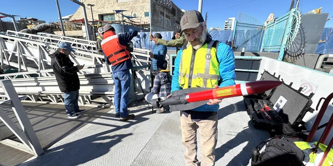 USGS scientist holding an AUV. USGS photo