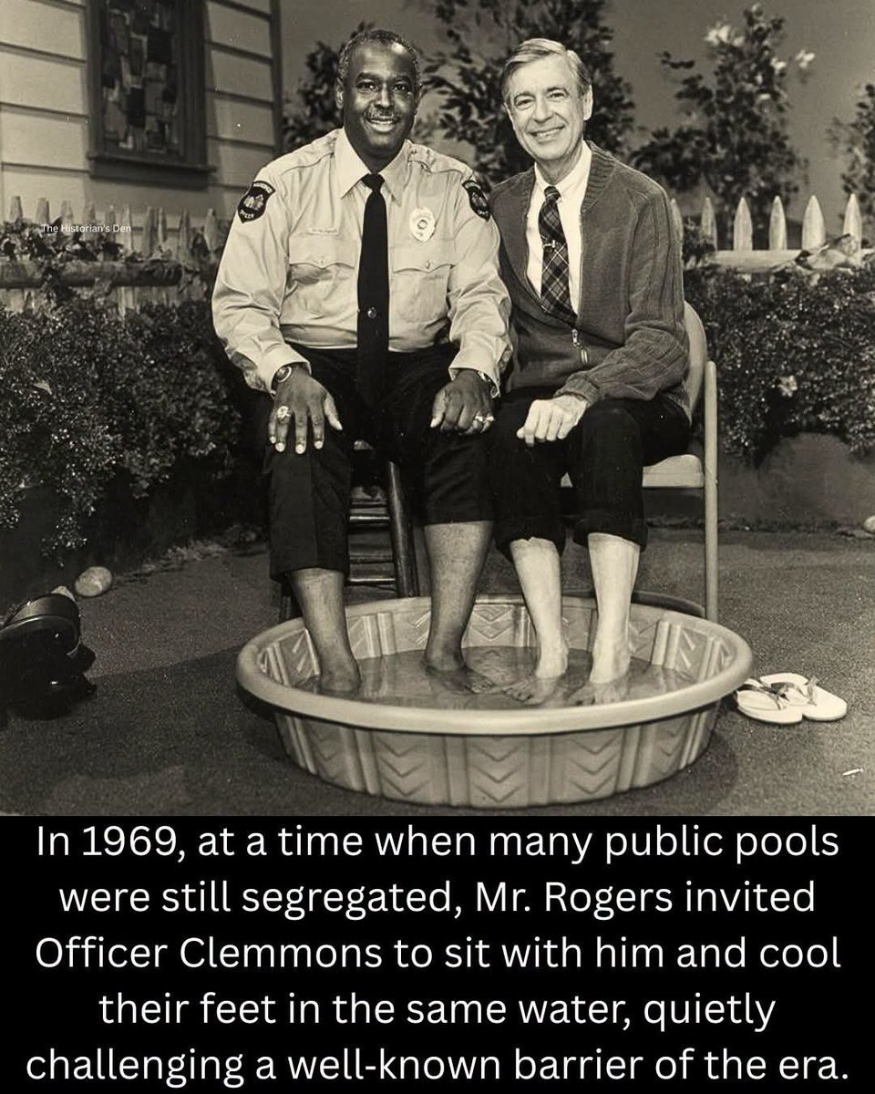 historical_Afr's tweet photo. The 1969 scene featuring Fred Rogers and François Clemmons remains one of the most quietly symbolic moments in American television. On Mister Rogers’ Neighborhood, Rogers invited Clemmons, who portrayed the neighborhood police officer, to join him in cooling their feet together in a small wading pool. The gesture was simple and unspoken, yet it carried weight at a time when racial tensions were still deeply embedded in everyday life across the United States.

During the late 1960s, public swimming pools were among the many spaces where segregation persisted, even after the Civil Rights Act of 1964. Black Americans were frequently barred from entering pools or faced hostility when they attempted to use them. Against this backdrop, Rogers’ invitation to Clemmons, an African American performer, served as a subtle but deliberate counter‑message. By sharing the same water, the show modeled a vision of equality and neighborliness that contrasted sharply with the realities many families experienced.

The moment did not rely on overt political statements; instead, it used the gentle tone of children’s programming to challenge a social barrier. Clemmons later reflected on how meaningful the gesture was, both personally and culturally. Today, the scene is often revisited as an example of how small acts in popular media can contribute to broader conversations about inclusion, dignity, and the slow, ongoing work of social change.

Cc: the history den
