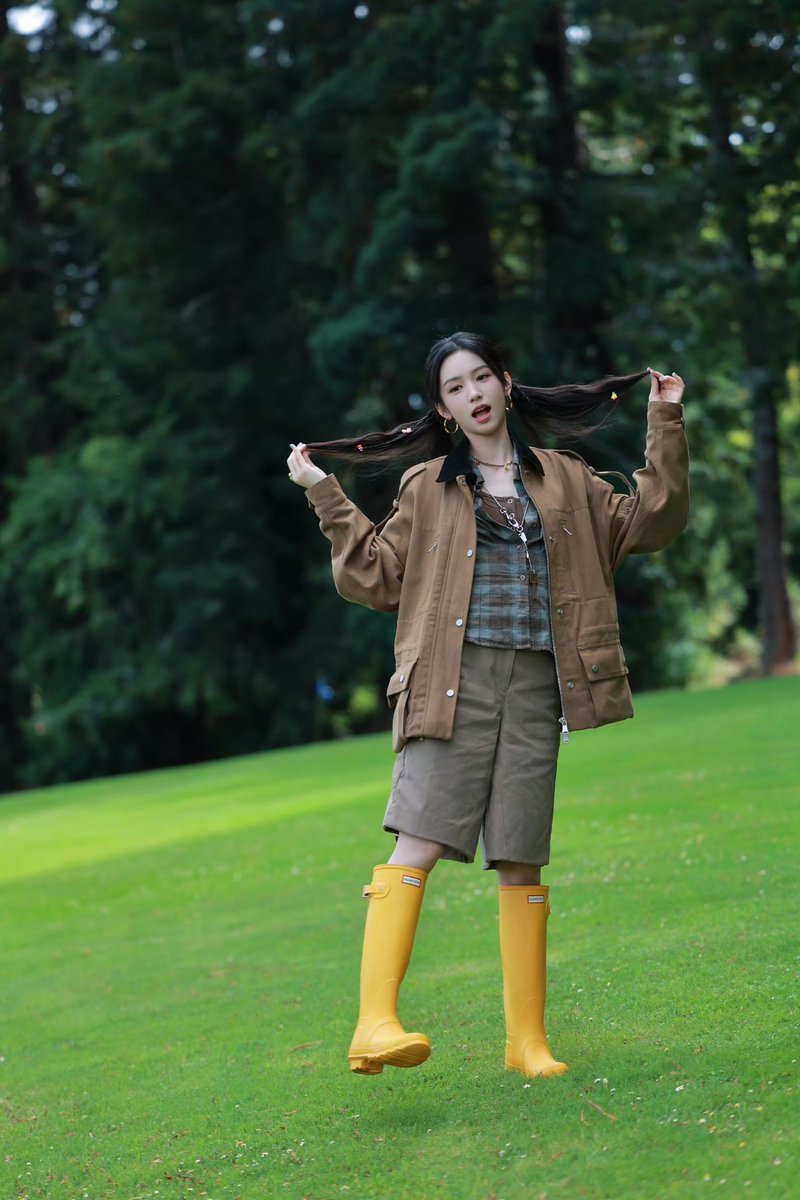 Her hair in two ponytails with cute clips and bright yellow boots