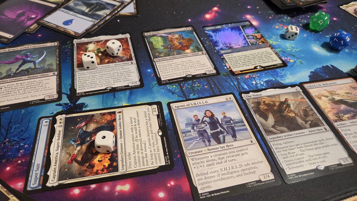GothMillie's tweet photo. Finally playing with my new #MTGxMarvel cards.  MODOK and The Cosmic Cube were too much for Captain America and friends.  🧊 https://t.co/bYprM8B8Wg