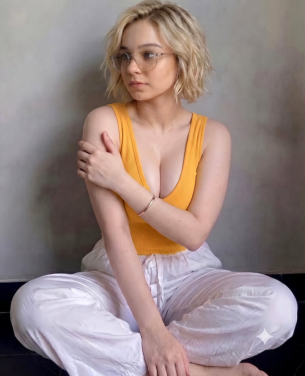 Jodie_Noraa's tweet photo. The New Outfit, Three Different Vibes. Smart Casual Weekend Set. Simple Colors & Gold Details.✨

Images Made With AI "Gemini Nano Banana Pro 3.1"

| Sadie Sink | Emma Myers |
| Millie Bobby Brown |

Here's the PROMPT of these AI generated pictures:👇 

"A highly detailed realistic photograph of a young woman with fair skin and vibrant reddish-orange hair styled in a high ponytail with loose strands framing her face, wearing thin gold-rimmed round eyeglasses, seated comfortably on a dark tiled floor against a plain light gray textured wall. She is dressed in a soft pink ribbed sleeveless tank top and loose white pants with a drawstring waist. Her pose shows her legs bent and drawn up towards her body, with one hand gently touching her hair near her ear and the other resting on her knee, conveying a calm and friendly expression with a slight smile. Soft natural lighting illuminates the scene evenly, highlighting her features and the textures of her clothing and hair. The composition is portrait-oriented with a clean, minimalist indoor studio aesthetic."