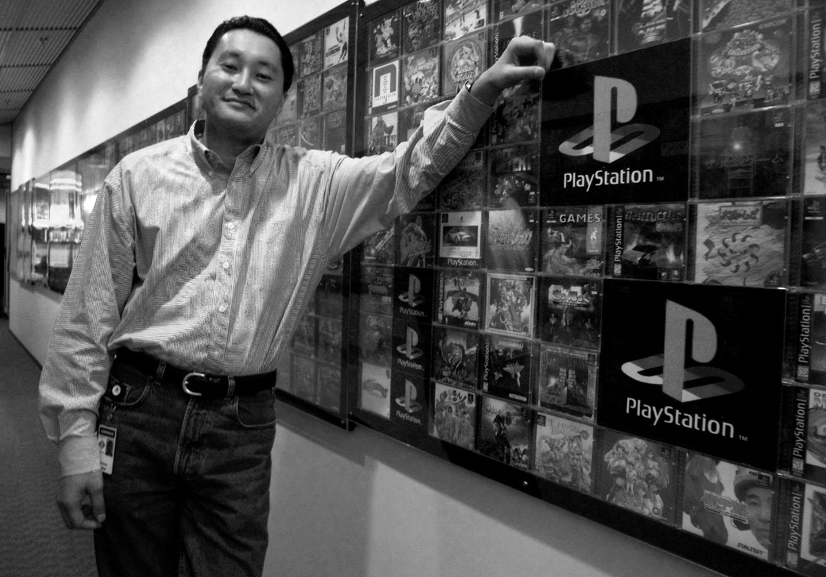 ObsoleteSony's tweet photo. Kaz Hirai proudly standing in front of a wall of physical PS1 games feels a little different now. https://t.co/Fv68wAM0q2