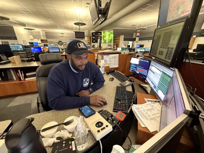 Orlando Fire dispatchers monitoring the emergency call traffic on his computer.