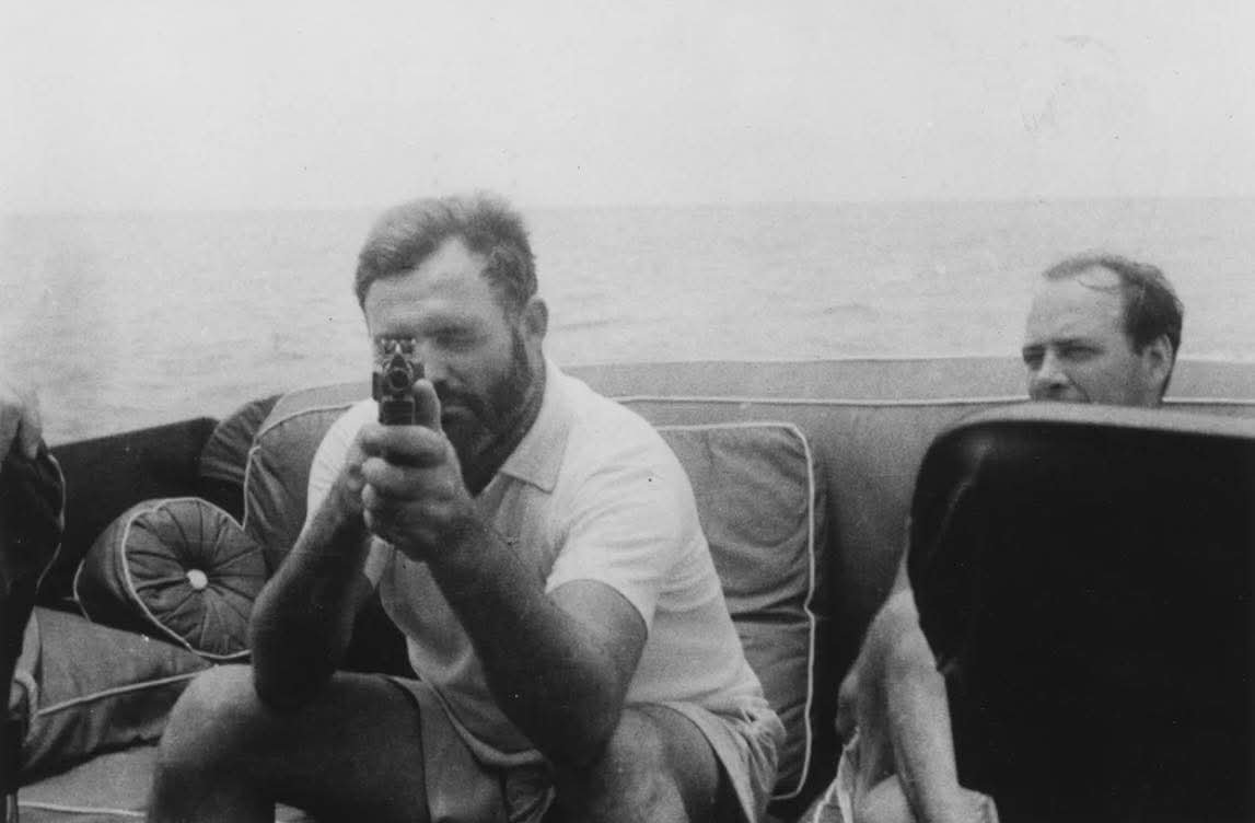 histories_arch's tweet photo. 1935: Ernest Hemingway, holding a tommy gun, aboard his yacht, the Pilar... 

This photograph captures Ernest Hemingway in his natural element: the open water, a boat, and a hint of danger. By 1935, Hemingway had already crafted a public persona built on adventure, physical courage, and the pursuit of intense experience. His yacht, the Pilar, was more than a fishing vessel. It was his floating refuge, writing studio, and occasionally, his staging ground for stunts that blurred the line between bravado and mythmaking.

During the mid 1930s, Hemingway became fascinated by the idea of hunting large game at sea, particularly marlin and tuna. But he was equally obsessed with the rising threat of Caribbean pirates who preyed on fishing boats. Whether the pirates were a real concern or simply gave him an excuse to bring weapons aboard is debatable. Still, the Pilar famously carried rifles, handguns, and even a Thompson submachine gun like the one he holds here.

Scenes like this contribute to the legend of Hemingway: the writer who insisted on living the adventure he wrote about, who blurred literature and life until they looked almost the same. It is an image of swagger, but also of a man who felt most alive when testing the edge.

During World War II, Hemingway volunteered the Pilar for anti-submarine patrols off Cuba, cruising the waters with weapons, grenades, and a crew he jokingly called his “Q-boat” unit, hoping to spot German U-boats.

#archaeohistories