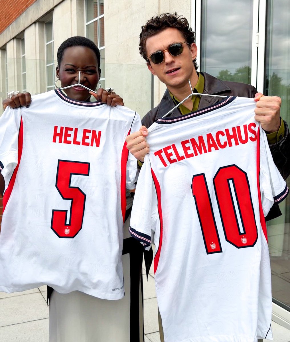 _filmcrave's tweet photo. Lupita Nyong’o and Tom Holland holding an England football shirt customized with the name of their characters in ‘THE ODYSSEY’. 📷 https://t.co/wxdiDfopzY