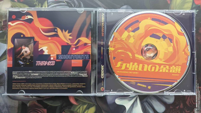 the inside of the cd case, featuring the back of the booklet (which shows some special thanks / shoutouts from JAKAZiD), and the disk itself.