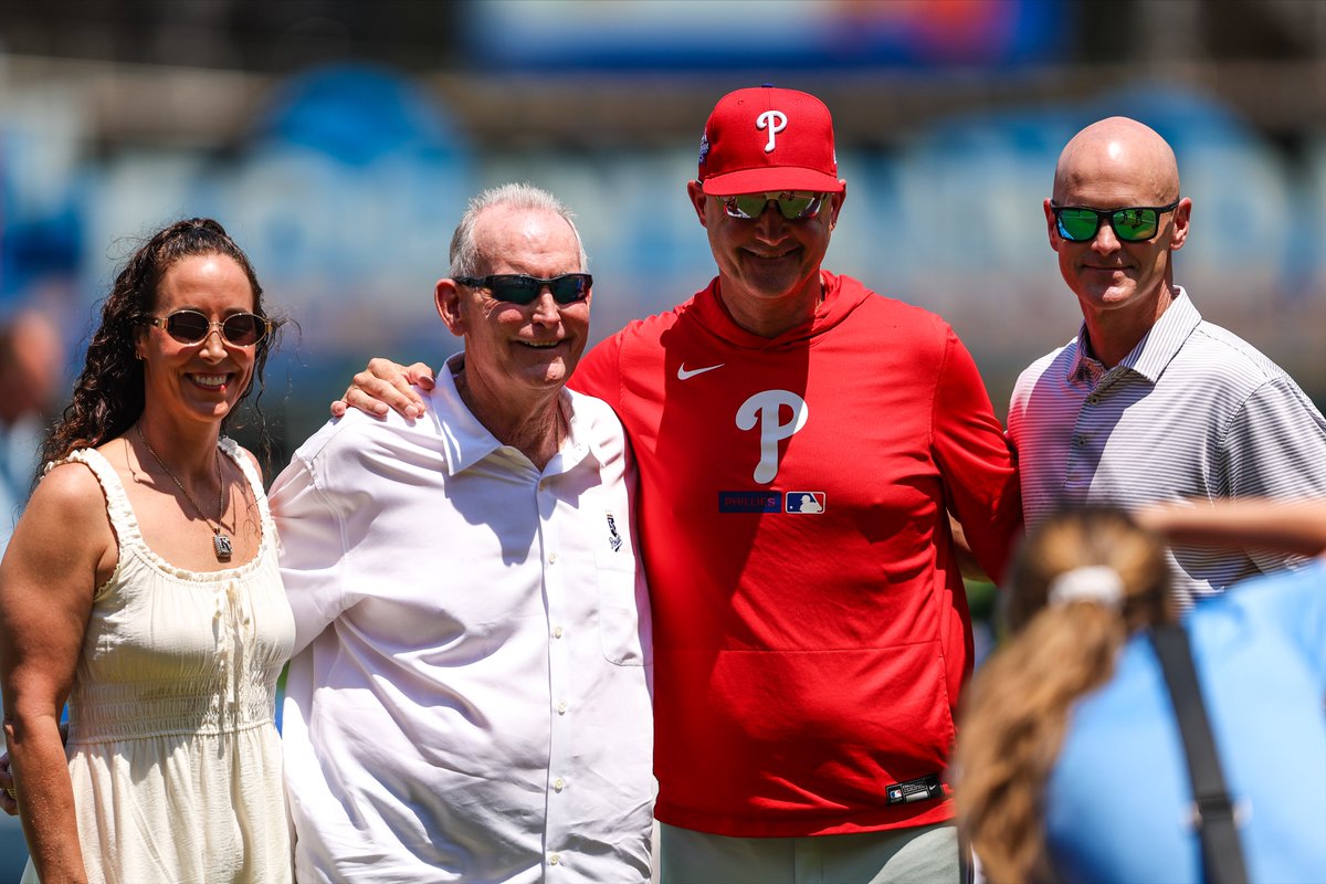 Phillies's tweet photo. Before today's game, Phillies bench coach Dusty Wathan caught the ceremonial first pitch thrown by his father, John. ❤️💙

John was inducted into the @Royals Wall of Fame today! https://t.co/eJUK0trRq2
