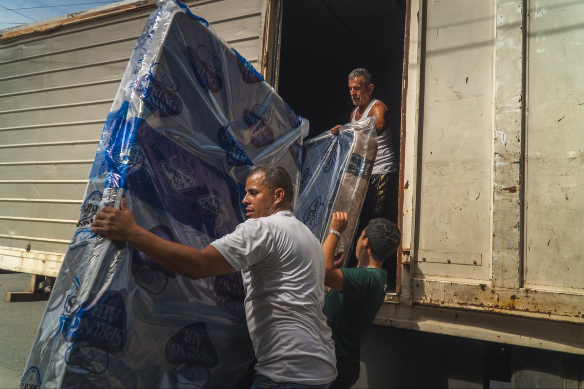 AllHandsHearts's tweet photo. 🇻🇪 Our team is helping set up a shelter in the Nuestra Señora de la Candelaria church in La Guaira, Venezuela, housing earthquake survivors. For days, people have slept on cement floors. We brought mattresses for more comfort for families to rest. Many will stay here until structural evaluations for their homes take place. With over 60,000 buildings severely damaged, it’s likely going to take months before they can return home. 

Additionally, we installed water filtration systems for safe drinking water and delivered cans of tuna and sardines for food, among other essential supplies such as diapers, electrolytes to combat severe dehydration, and medicines.

Help us continue our response: https://t.co/RWQVjo6JUy