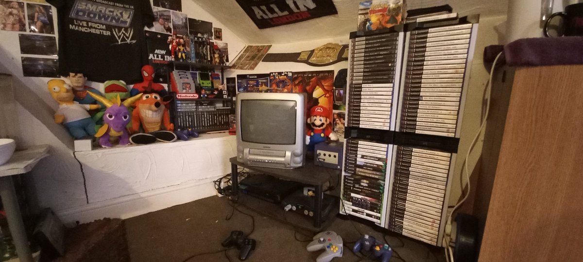 AdamsCrapTweets's tweet photo. Retro Corner! Work in progress. 

I wanted it to sort of have the effect of like playing games on a Saturday morning as a kid. The video on the CRT *does* work.

This has an ongoing project to get physical copies of every game I ever had (95% done) and every game I wanted. https://t.co/G1wlgm7Tsf