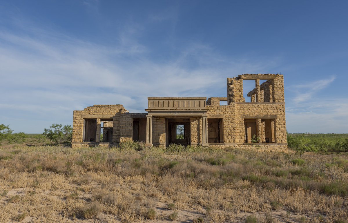TracesofTexas's tweet photo. The former Upton county courthouse in the ghost town of Upland.  Per the Texas State Historical Association:   "Upland was located near the geographic center of Upton County northwest of the site of present-day Rankin. The town was platted by Henry M. Halff in about 1908 and grew quickly to include numerous businesses, a church, and a school that began in October 1908. A post office opened in 1907 with Edward B. Coatwright as postmaster. To encourage development, Halff sold both businesses and residential lots and built a hotel and a general store. Future prosperity seemed assured when Upland was proclaimed the first county seat on May 7, 1910. Later that year W. D. Riser established the Upland Roundup, the first county newspaper.

But droughts, bad soil, and lack of adequate water sources hinted of impending disaster. The final blow came when the Orient Railroad built south of the town about 1911, causing many residents to leave. The hotel was moved to Rankin in 1912, and the newspaper followed three years later. In 1915 Rankin became the county seat. By the time the post office closed in 1918, Upland's population had dwindled to a few families. Nothing remained of the former county seat by the 1980s."

It's kind of sad to see the old courthouse standing out there all by its lonesome, isn't it?

Photo by Aualliso.