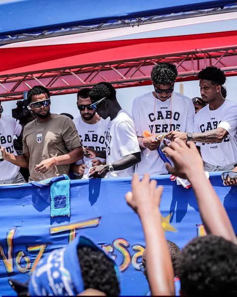 auntiededei's tweet photo. Cabo Verde returned home to a hero's welcome in the capital, Praia, after their impressive FIFA World Cup campaign. Thousands of jubilant fans lined the streets to celebrate the Blue Sharks, whose historic performances captured the hearts of the nation and earned global admiration. 🚨🇨🇻

#AuntieDedei #capeverde