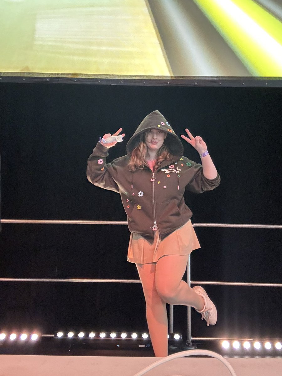 CutieMelonVT's tweet photo. Playing Nintendo Wii Spots on the big Stage!  Wearing my new favorite hoodie from SoyToy! 

@TeamAVCon_ #avcon2026 https://t.co/jU2E2HvbGq