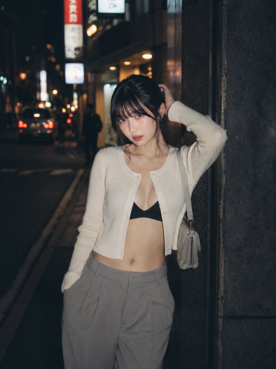 CyberTotal2026's tweet photo. 夜の路地で、白いカーディガンだけが静かに浮かんで見えた。
まっすぐな視線に、少しだけ帰り道の熱が残っている。🌙❤️

#AIart️️️️️️️️️️️️️️️️️️️️️️️️️️️️️️️️️️️️️️️️️️️️️️️️️️️  #AI写真

【GPT Image2プロンプト】
主題：夜路地

人物・表情：
20代女性。幼さのない自然で成熟した雰囲気。黒茶色のミディアムヘアをゆるくまとめ、薄い前髪と顔まわりの後れ毛を残す。清透な日系写真メイク、自然な肌の質感。唇は控えめな血色感。顔を少し傾け、カメラをまっすぐ見る落ち着いた表情。

服装・ポーズ：
白〜アイボリーの細リブニットカーディガンを前開き気味に着る。インナーは黒のシンプルなブラトップ、下はグレーのハイウエストワイドスラックス。小さなライトグレーのショルダーバッグを片肩にかける。身体は画面左へ少し傾け、背中を暗い石壁に軽く寄せる。人物自身の左手を後頭部に添え、右手はパンツのポケットに入れる。指先は自然に曲げ、肩と腰にゆるい重心差をつける。上品で控えめな大人の街頭ポートレート。

背景・光：
東京の夜の裏通り。暗いビル壁、細い歩道、奥にぼけた車のテールランプ、看板灯、街灯の丸い光。背景の文字は読めない程度にぼかす。路面は少し湿っていて、街灯の反射が細く伸びる。人物の正面やや左上から弱いフラッシュのような白い光が当たり、顔、白いカーディガン、肩まわりを浮かび上がらせる。背景は深く沈み、奥の光だけが暖色のボケになる。

構図・カメラ：
縦構図 4:5。腰上から太もも上まで入るミディアムショット。人物は画面右寄りに配置し、左側に夜道の奥行きと暗い余白を残す。カメラは胸元より少し高い位置からほぼ平視。人物との距離は近めで、背景は浅めにぼかす。スナップ写真のような自然な距離感。焦点は瞳と顔まわり。

質感・スタイル：
高品質な日系写真。夜のフラッシュ撮影風、やや粒子感のあるフィルムライクな質感。肌は過度に滑らかにせず、毛穴や光沢を自然に残す。黒、アイボリー、グレー、暖色ボケを中心にした落ち着いた色調。過度なHDRや広告写真風ではなく、少し湿度のある都会の夜の空気感。

ネガティブ：
未成年、幼い顔、過度な露出、透ける服、露点、低俗なポーズ、誇張された身体、同じ顔の複製、不自然な視線、余分または欠けた指、手足の融合、関節の破綻、バッグや服との接触不良、不自然な重力、背景文字の判読、ロゴ、透かし、過度な美肌補正、プラスチックのような肌、過度なHDR、強すぎるAI感。