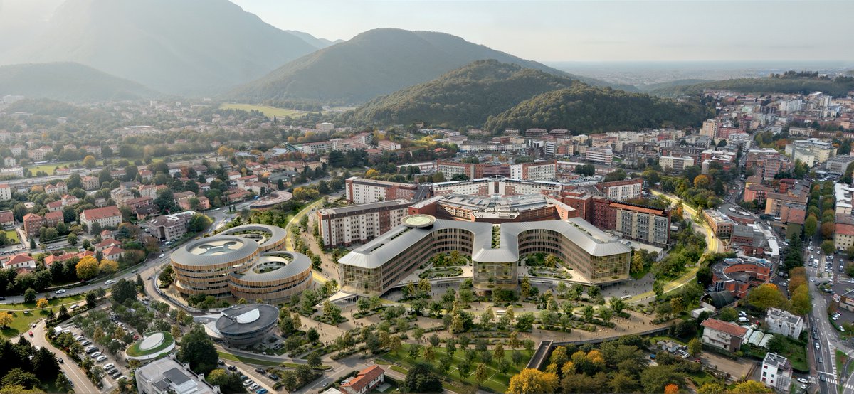 TheB1M's tweet photo. Can a hospital function like a park? Italy is working to find out, as it constructs a major new hospital around a 1-kilometre green ring 🌿

The international competition to design Brescia’s €274M Hospital of the Future was won by a CRA-Carlo Ratti Associati-led team. Its proposal features a new 745-bed medical campus linked by a kilometre-long landscaped “CareRing” that separates logistics from patient movement.

The project also uses a hybrid timber-and-steel structure designed to reduce embodied carbon and allow future expansion.

Construction works are due to start in 2028.

📷 CRA-Carlo Ratti Associati
