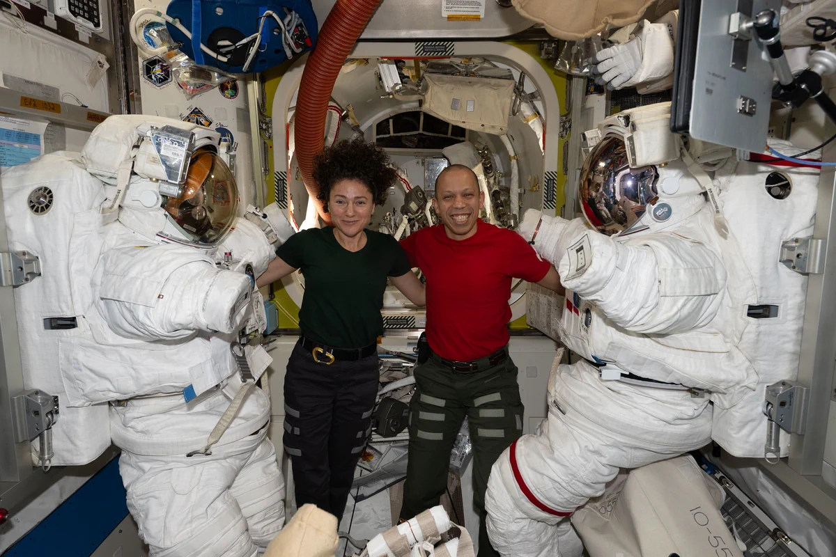 NASA astronauts Jessica Meir and Chris Williams, both Expedition 74 flight engineers, pose with their spacesuits inside the International Space Station's Quest airlock. The following day, Meir and Williams wore the suits and exited Quest to conduct a seven-hour-and-20-minute spacewalk and replace a malfunctioning wrist joint on the Canadarm2 robotic arm.