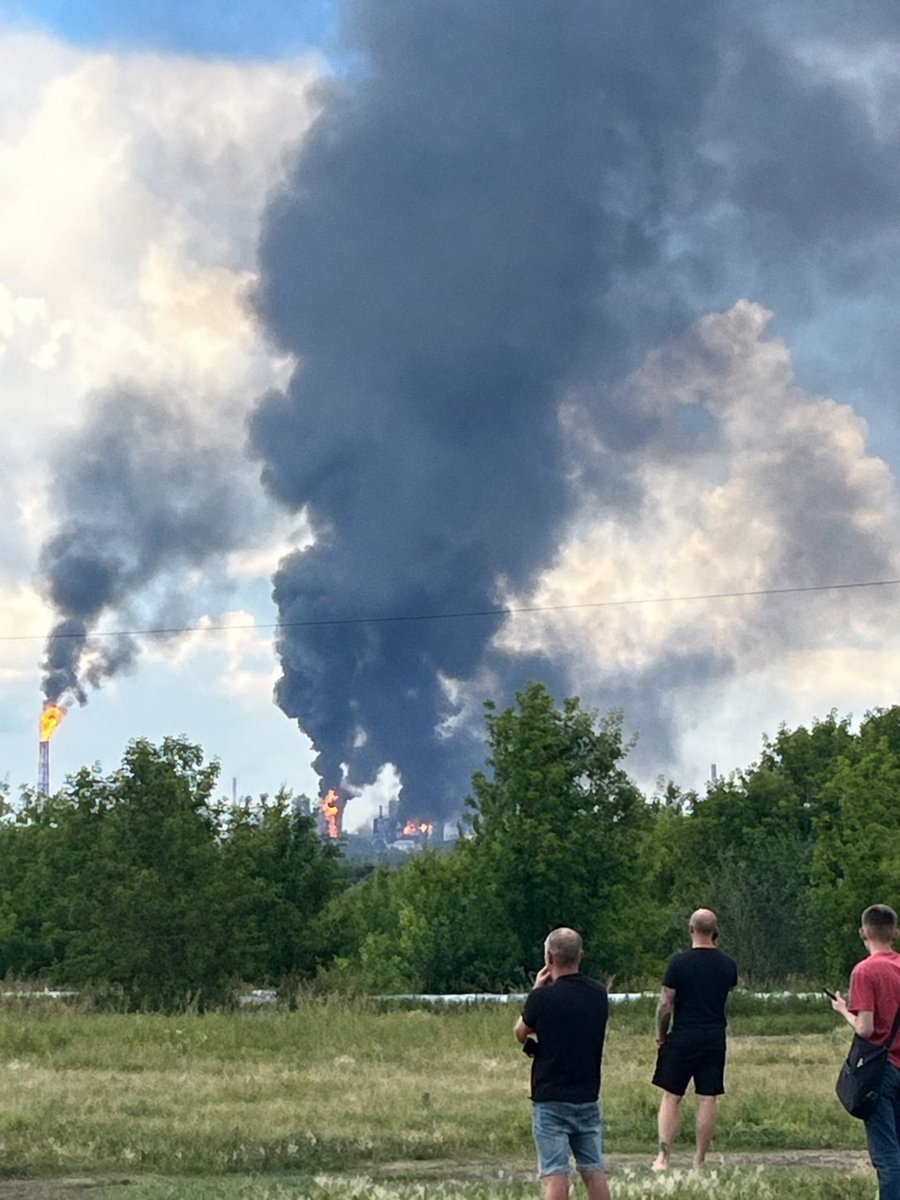 NAFOvoyager's tweet photo. Ukrainians are waiting as rescuers search for their loved ones beneath the rubble.

russians are watching an oil refinery burn.

That's the difference. https://t.co/0OGirlVB8y