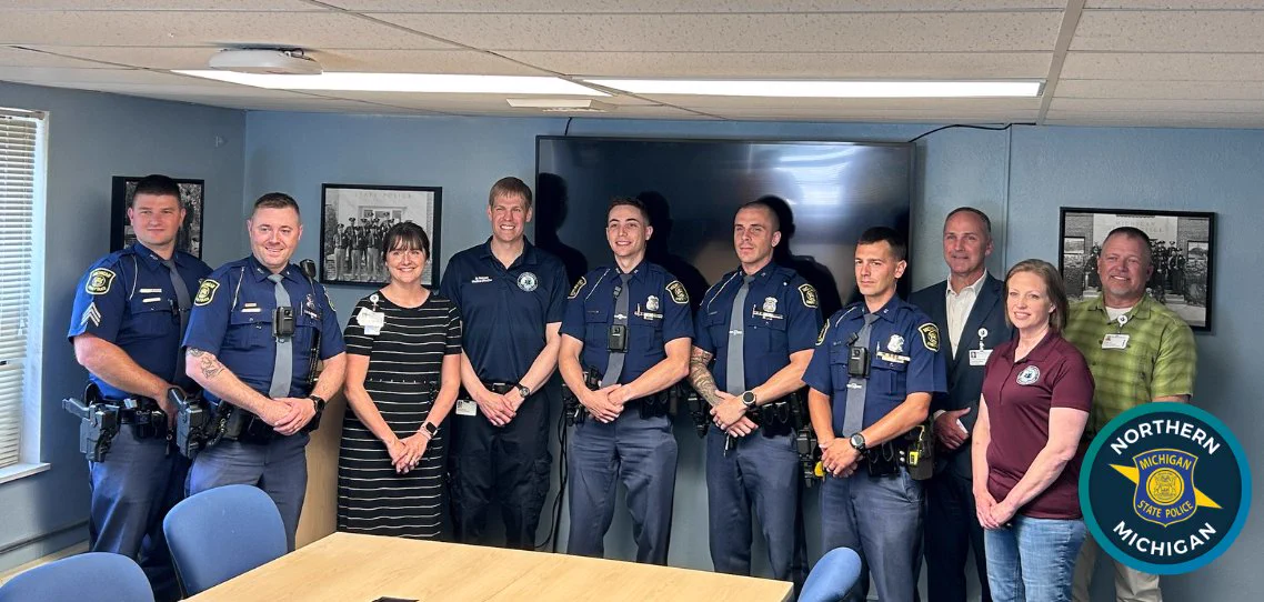 Troopers standing with staff from Munson Healthcare System.