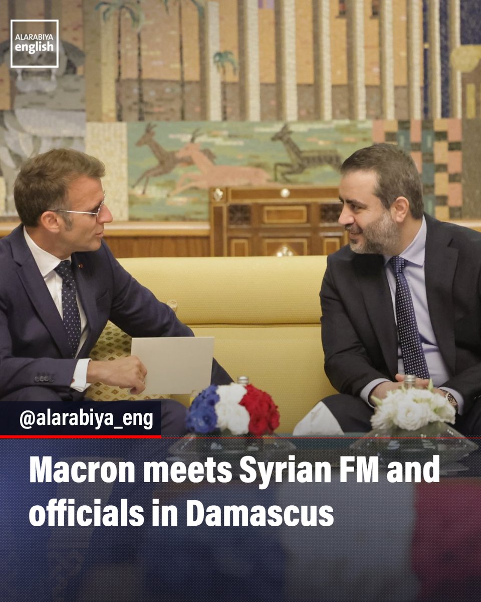 French President Emmanuel Macron is welcomed by Syrian Foreign Minister Asaad Al Shaibani upon his arrival in Syria for his first official visit to the country.