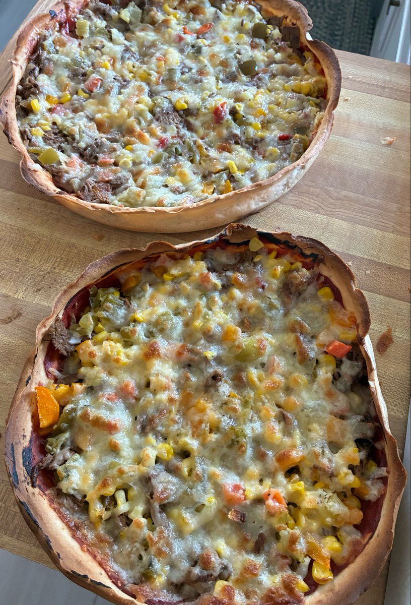 StofMoney's tweet photo. Sourdough crust pizza. First one is a hot Italian venison with giardiniera &amp; the other is a kind of margherita with fresh picked basil.

@ClaudesBBQ https://t.co/b8NpzDP0my