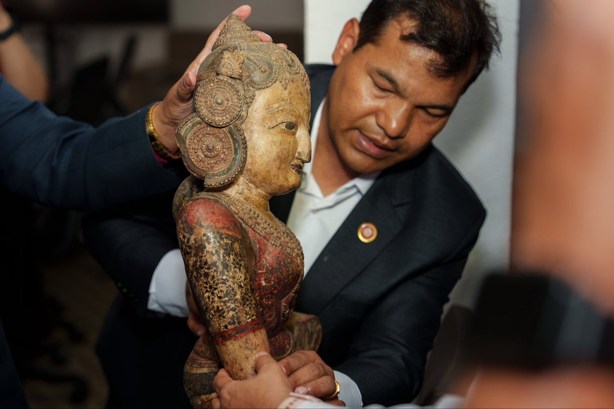 USEmbassyNepal's tweet photo. Yesterday, at a repatriation ceremony hosted by Nepal’s Department of Archaeology, two sacred treasures returned home: a 13th-century gilt bronze Padmapani and a 16th-century polychromed wooden Nrityadevi.
 
The United States is proud to partner with Nepal in the return of these significant cultural artifacts, reflecting years of close cooperation to combat the illicit trafficking of cultural property and restore sacred objects to the communities where they belong. The newly enacted U.S.-Nepal Cultural Property Agreement builds on this longstanding partnership and provides a stronger framework for future collaboration, including joint efforts to support investigations, prevent trafficking, and safeguard Nepal’s rich cultural heritage.
 
“To date, 127 Nepali antiquities have been returned from the United States to their rightful homes in Nepal,” said Public Affairs Chief Mike Harker. “With the return of these two sacred statues, that record of cooperation grows stronger and demonstrates how criminal investigations, diplomatic coordination, and community advocacy can work together to disrupt antiquities trafficking networks. The new U.S.-Nepal Cultural Property Agreement gives our two countries an even stronger foundation to build on this work, support future investigations, and help prevent Nepal’s sacred heritage from entering the illicit market.”
 
The United States congratulates the Government and people of Nepal on this important milestone and remains committed to working alongside Nepal to protect cultural heritage, uphold the rule of law, and preserve the country’s remarkable history for future generations.