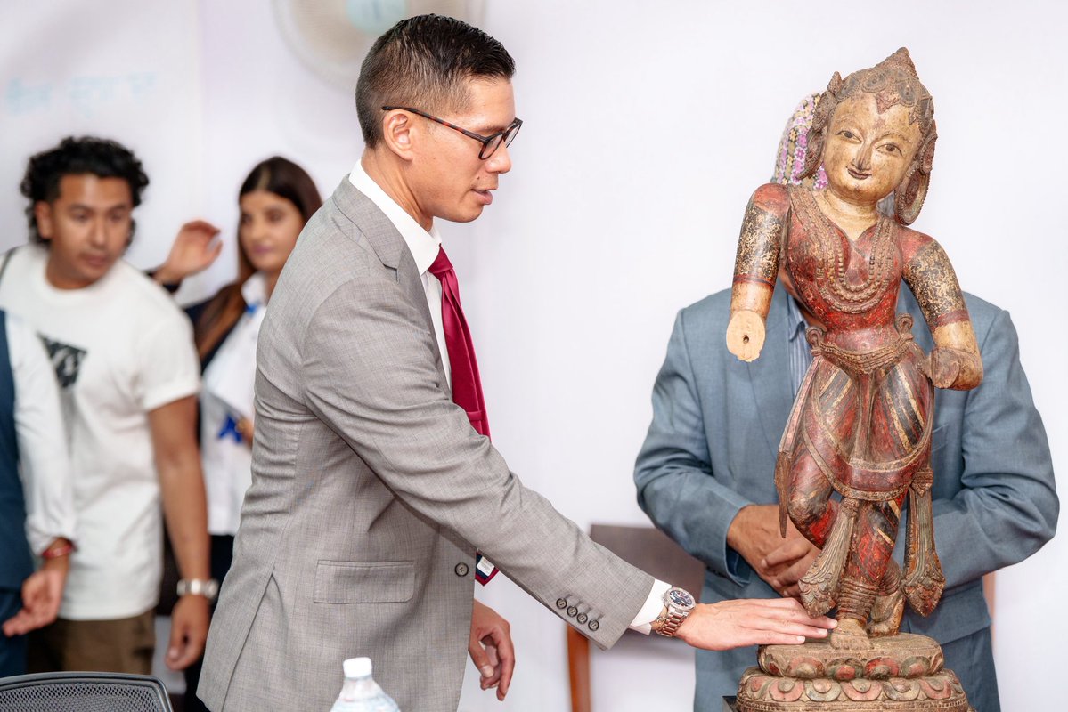 USEmbassyNepal's tweet photo. Yesterday, at a repatriation ceremony hosted by Nepal’s Department of Archaeology, two sacred treasures returned home: a 13th-century gilt bronze Padmapani and a 16th-century polychromed wooden Nrityadevi.
 
The United States is proud to partner with Nepal in the return of these significant cultural artifacts, reflecting years of close cooperation to combat the illicit trafficking of cultural property and restore sacred objects to the communities where they belong. The newly enacted U.S.-Nepal Cultural Property Agreement builds on this longstanding partnership and provides a stronger framework for future collaboration, including joint efforts to support investigations, prevent trafficking, and safeguard Nepal’s rich cultural heritage.
 
“To date, 127 Nepali antiquities have been returned from the United States to their rightful homes in Nepal,” said Public Affairs Chief Mike Harker. “With the return of these two sacred statues, that record of cooperation grows stronger and demonstrates how criminal investigations, diplomatic coordination, and community advocacy can work together to disrupt antiquities trafficking networks. The new U.S.-Nepal Cultural Property Agreement gives our two countries an even stronger foundation to build on this work, support future investigations, and help prevent Nepal’s sacred heritage from entering the illicit market.”
 
The United States congratulates the Government and people of Nepal on this important milestone and remains committed to working alongside Nepal to protect cultural heritage, uphold the rule of law, and preserve the country’s remarkable history for future generations.