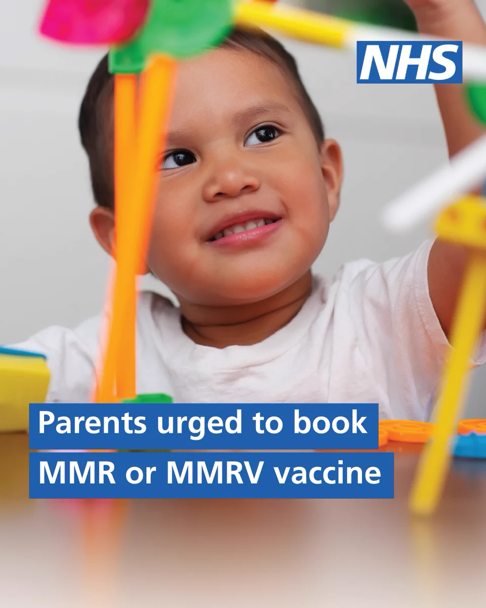 Smiling toddler playing with colorful toys, highlighting the importance of MMR or MMRV vaccination for children.
