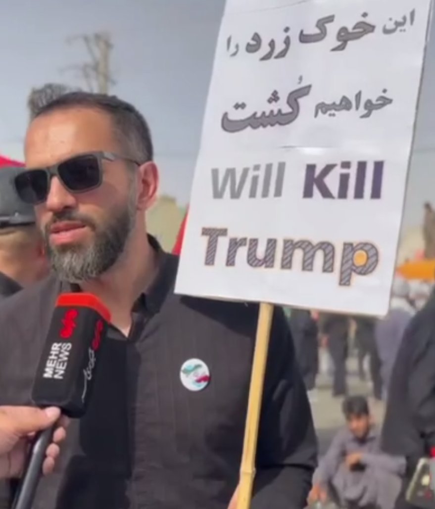 Realneo101's tweet photo. 🚨 Just In: Islamic regime loyalist is holding a sign reading, "We will kill this yellow pig," referring to President Trump. https://t.co/vq7zdSr5kV