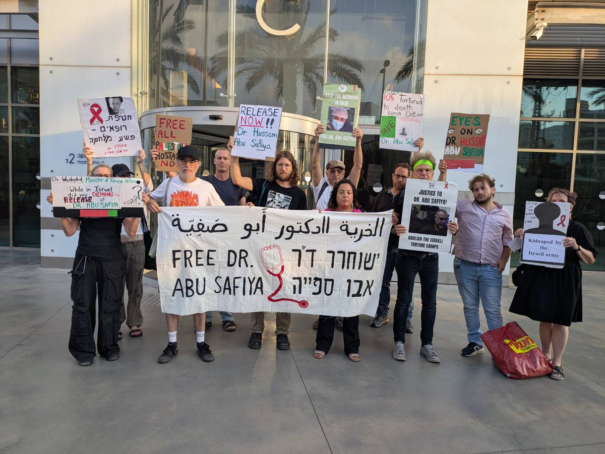 itamar_green's tweet photo. Right now:
Group of activists gathered outside the German Embassy in Tel Aviv during the visit of German Foreign Minister Johann Wadephul: "Never Again Means Never Again for anyone"

We demanded that Germany pressure Israel to immediately release Dr. Hussam Abu Safiya and the other medical personnel abducted from Palestinian hospitals, as well as the thousands of Palestinian prisoners and detainees held captive and tortured in the Israeli prisons.

"If you and your government remain silent, the blood is on your hands too. Free Hussam - free them all."