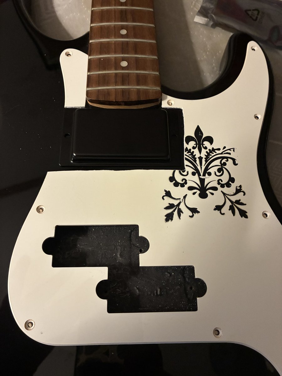 AdelaideSmyth's tweet photo. I'm modifying my bass guitar and I decided to use a POSCA marker last night to make swirls and paisley designs on the pickguard.

(Before; the fleur-de-lis etc. decal had been there for 10+ years and then I had to cut part of it off to accommodate moar electronics) https://t.co/44TVzVjiML