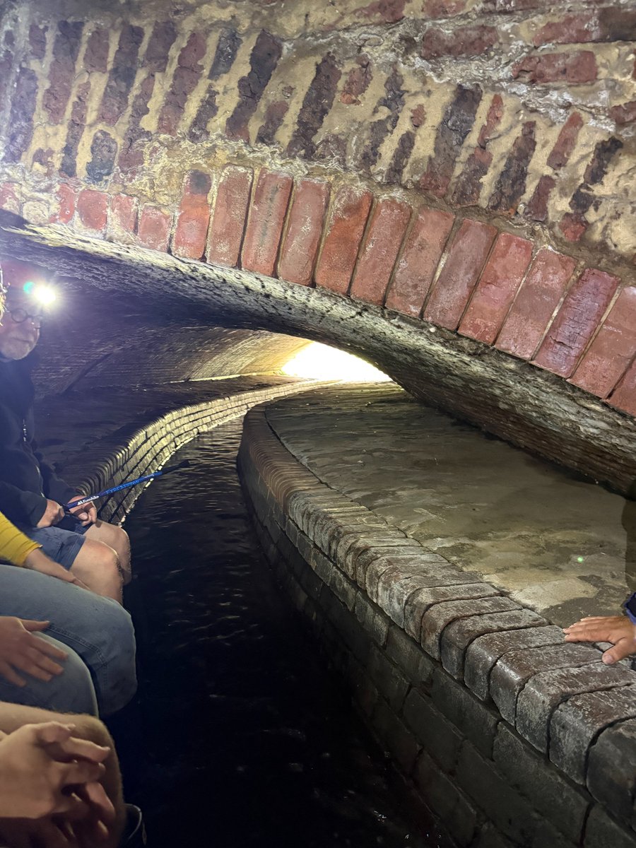 davidrichards's tweet photo. The best tourist attraction in Britain that almost nobody has heard of is hidden beneath Sheffield.

For centuries the River Sheaf flowed through the heart of the city, crossed by stone bridges that connected a growing market town. Then, in the late nineteenth century, the Victorians did something astonishing. They buried the river inside vast brick culverts so they could build the railway station and expand the city above it. Walk the tour today and you can still see those original bridge arches, frozen in time, spanning a river that no longer sees daylight.

The scale of the engineering is breathtaking. Standing inside the “Megatron”, the enormous Victorian chamber beneath Sheffield Station, you realise this wasn’t just a drain. It was the infrastructure that allowed modern Sheffield to exist. Above, thousands of passengers cross the platforms every day, many unaware that the river which gave the city its name is flowing directly beneath them. There’s even a small viewing porthole between platforms 2 & 5 where you can catch a glimpse of it.

If you’re anywhere near Sheffield, do this tour. It is history, engineering and urban archaeology rolled into one, and one of the most remarkable experiences I’ve had in any British city. Sheffield has many hidden gems. This is the one hiding beneath them all.

Even the graffiti has become part of Sheffield’s folklore... Bill Drummond, co-founder of The KLF, somehow feels like the perfect epitaph for Sheffield’s hidden river:

“Is the river really beautiful or is it just the gradient of the land?”