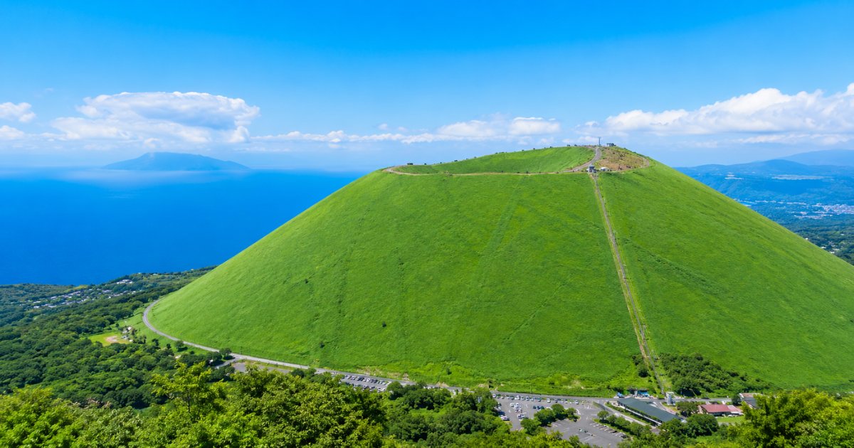 TRAVELISTjp's tweet photo. まるで抹茶プリンのような、なめらかなシルエット。⛰️🌿

伊豆を代表する絶景スポット「大室山」は、リフトで山頂へ上がれば360°の大パノラマが広がります。夏は鮮やかな緑に包まれ、相模湾や伊豆の山々を一望できる開放感は格別。

次の休日は、伊豆で自然を満喫する旅へ。

✈️航空券を比較して、おトクに旅しよう！

#大室山 #伊豆旅行 #静岡観光 #絶景スポット #国内旅行 #トラベリスト