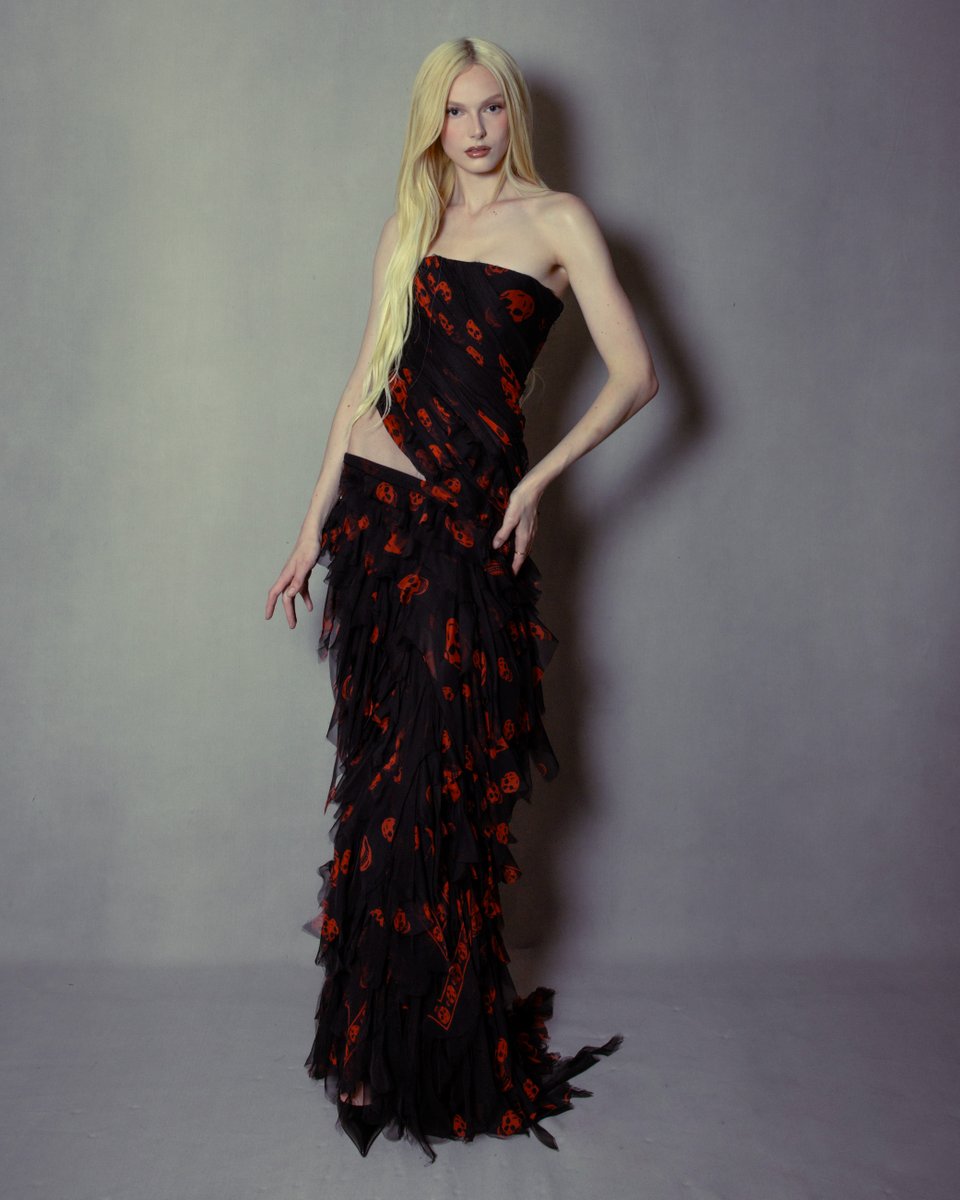 McQueen's tweet photo. Documenting McQueen 
Episode 4: The Skull

A skull print dress with hip slash detail in black and red distressed silk georgette. Custom McQueen for Alex Consani at the British Fashion Awards 2025.

Discover the full episode: https://t.co/0HZaRLDP3D

Captured by Chanel Moye 
Alex Consani captured by Ronan Park