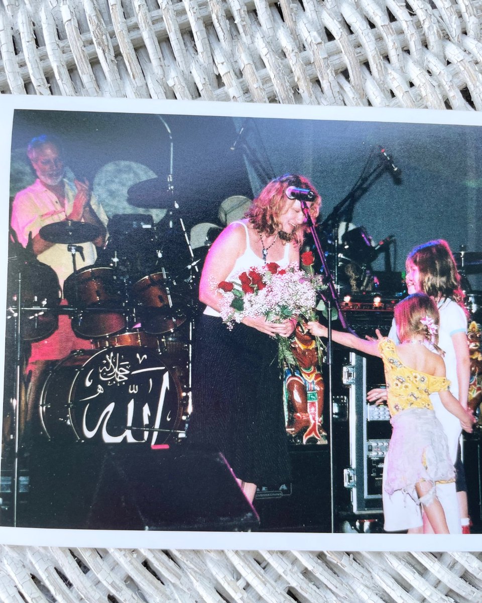 joan_osborne's tweet photo. I’ve sold my house, am now emptying it out. Quite an exercise is personal archeology. Found these photos of my birthday in 2003, onstage with #TheDead at #RedRocks in Colorado. @BobWeir and @BKreutzmann to my left and right, Bob’s daughters (and #PhilLesh's son?) giving me roses. https://t.co/XwsbEYzN01
