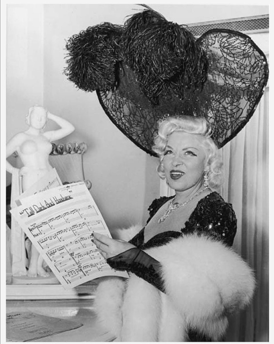 CitizenScreen's tweet photo. Mae West holding the sheet music for 'Tall, Dark and Handsome’ in July 1954 during her nightclub engagement at the Hotel Sahara in Las Vegas. https://t.co/OoQ27fyjea