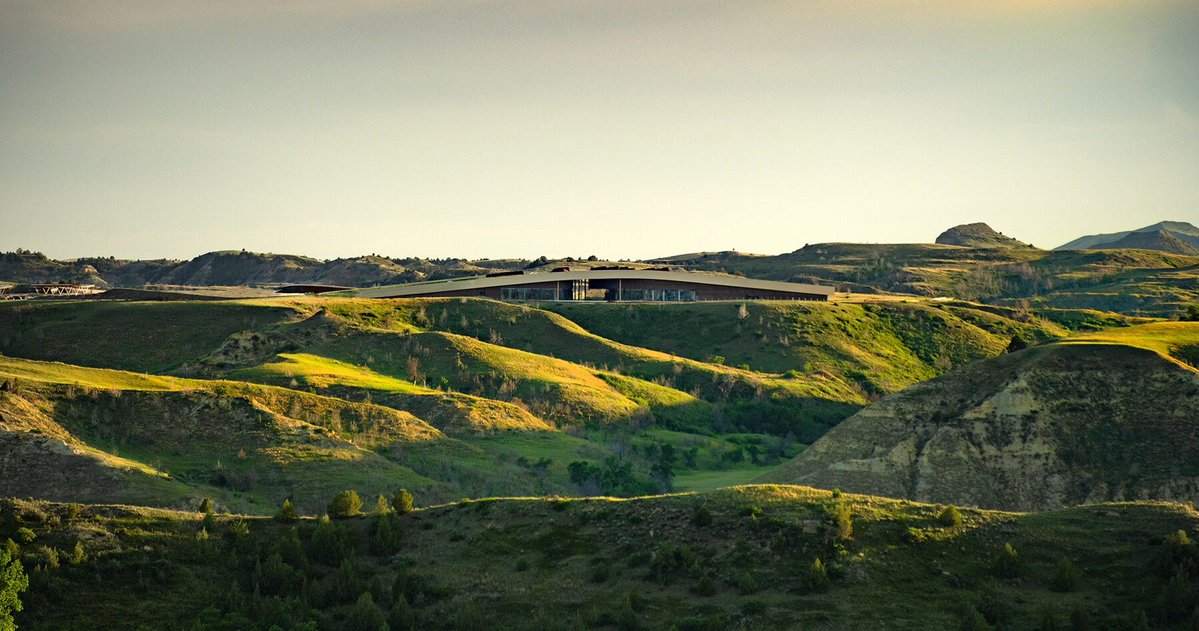 designboom's tweet photo. snøhetta’s theodore roosevelt presidential library emerges from the north dakota badlands with a living prairie roof that invites visitors to walk across the landscape.

built from mass timber, rammed earth, and locally sourced materials, the project reimagines the presidential library as an extension of the land while pursuing one of the world’s most ambitious sustainability standards.

#architecture #sustainability #design