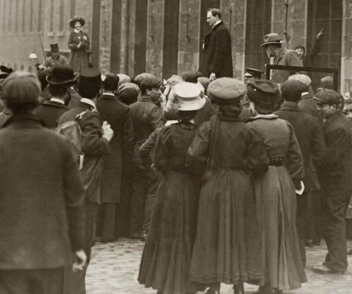 historyinmemes's tweet photo. Mary Maloney confronted 34-year-old Winston Churchill over remarks he had made criticizing women’s suffrage. When he refused to apologize, she repeatedly rang a large bell each time he tried to speak, drowning out his voice and bringing the meeting to a standstill.

Mary Maloney was an Irish suffragette born near Dublin in 1878. She was initially a member of the Women’s Social and Political Union before joining the breakaway Women’s Freedom League, which favored civil disobedience over property damage.

Her best-known clash with the 34-year-old Winston Churchill came during the 1908 Dundee by-election, when he was campaigning to return to Parliament. Maloney followed him from one campaign event to another, demanding that he apologize for his dismissive comments about women’s suffrage.

Each time Churchill attempted to speak, she rang a large handbell, often drowning out his voice. At one factory meeting, he eventually gave up trying to continue, remarking that if she believed the bell was a valid argument, she was welcome to keep ringing it.

The press dubbed her “La Belle Maloney,” and her week-long campaign made her one of the most recognizable suffragette activists of the period. She later staged other high-profile protests, including climbing the statue of Richard the Lionheart outside the Palace of Westminster and refusing to come down until she had finished delivering a speech calling for votes for women.

Although Churchill’s position on women’s suffrage softened over time, he repeatedly opposed the full voting rights sought by campaigners, making him a frequent target of suffragette protests.

Women over the age of 30 who met certain property qualifications gained the right to vote in 1918, while equal voting rights with men were finally established in 1928.
