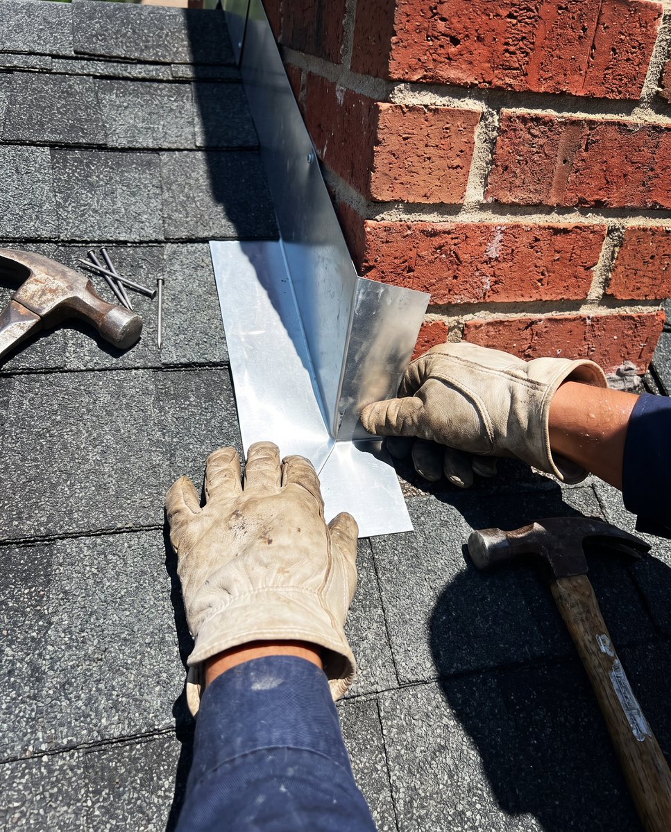TexasHomePro's tweet photo. The whole job comes down to this seam.

Where a brick chimney meets new shingles is the place a roof either holds or fails. Step flashing has to be cut to length, bedded in roofing cement, woven through the courses, and counter-flashed into the mortar joint above. Skip a step and https://t.co/KaBrDvKa9n