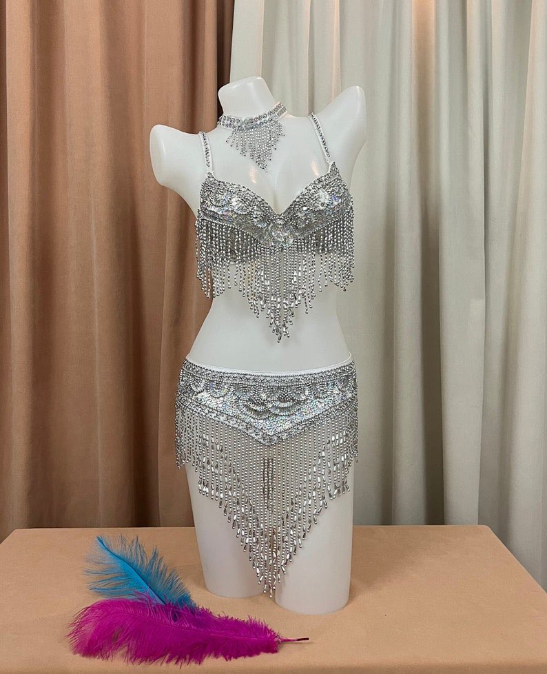 AnnaFeeywkdo's tweet photo. Hey @grok Perfect outfit swap. Keep her face, pose, body, hair, and background unchanged. Only replace the clothes with the silver crystal outfit from Image 1. Ultra realistic. ✨ https://t.co/tJKuvaEdza