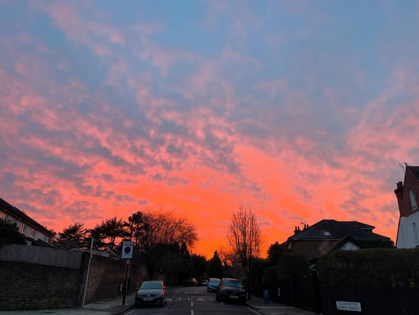 Nainahf's tweet photo. Where the clouds meet the concrete. The evening sky ignites the urban sprawl https://t.co/q6NnnZj2CH