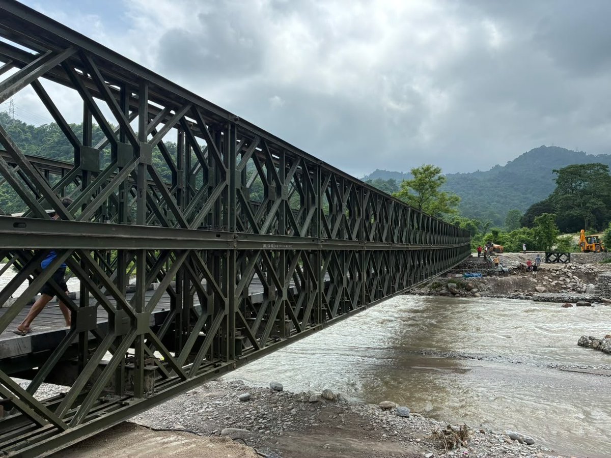 TheDarjChron's tweet photo. A BRIDGE OVER BALASON

In October 2025, when the original bridge over Balason river at Dudhey was washed away, Darjeeling MP Raju Bista wrote to then Chief Minister Mamata Banerjee, requesting that a Bailey Bridge be constructed to restore connectivity.

Dudhey bridge is vital, as it connects the Mirik region to the plains.

Yet, CM Mamata Banerjee turned a complete deaf ears to the request and chose not to reach out to the Army. Instead she constructed a hume-pipe bridge. Such hume-pipe bridges are used in slow moving and less water areas, whereas Balason is a mighty river that originates in Darjeeling hills. It carries the water from multiple smaller rivulets – and travels with a lot of force and speed.

So, building a hume-pipe bridge over such a mighty river was stupid – but TMC Chief was known to take such stupid decisions. In the very first rain of monsoon this year, on the night of June 18-19, 2026 the hume-pipe bridge was washed away, once again severing the connection between Mirik and rest of the state.

Darjeeling MP Raju Bista once again reached out to the Chief Minister, only this time its the BJP Government, and thankfully Suvendu Adhikari is the CM and not Mamata Banerjee.

Within 5-days of the hume-pipe bridge being washed away, a walkable Bailey Bridge was constructed by the Indian Army, and on Day-19, today a motorable Bailey Bridge has been completed, which will be open for traffic from tomorrow evening.

This bridge not only symbolizes the change in governance style, but also marks the priority of the government. We had a TMC government that refused to officially notify a disaster, and we now have a government that actually cares enough to get the bridge over Balason constructed in a timely manner.

We share our gratitude to Darjeeling MP Raju Bista for relentlessly pursuing, and CM Suvendu Adhikari for caring. Indian Army, PWD and others for constructing this vital link.

Hopeful new beginnings.

@adgpi @easterncomd