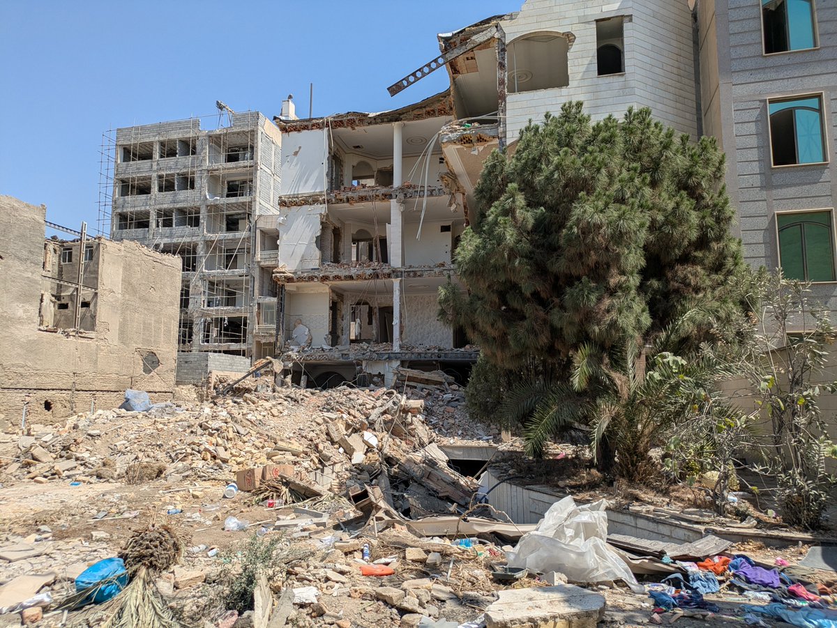 MaxBlumenthal's tweet photo. At the site of an American strike in a densely populated residential neighborhood in eastern Tehran on 3/9

40 were killed here with 8 missiles, including a family of 12

I found children's clothes in the rubble

Some 40-50,000 residential units were damaged in Tehran alone https://t.co/ojt7aOVUec