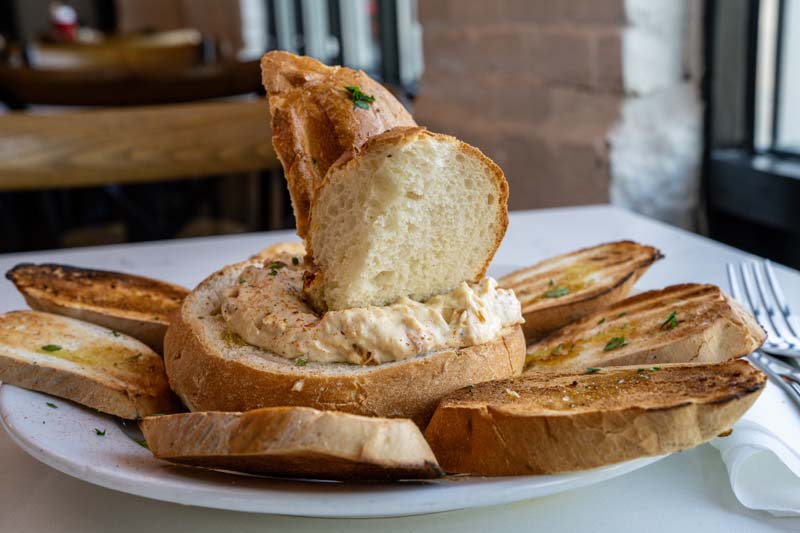 JAMEateries's tweet photo. If you're only ordering one appetizer, make it the Crab Dip 💙💛
.
Homemade crab dip served warm in a toasted bread boule with crispy bread slices made for dipping 🦀🥖
.
Trust us... you'll be scraping the bowl before the entrées even arrive.
.
➡️ https://t.co/VRuEg5HIQx
. https://t.co/gCe59ZDWVl