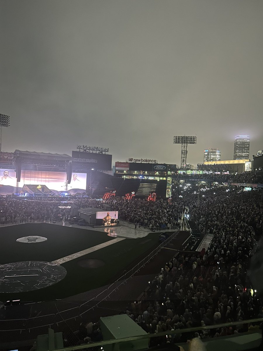 Buccigross's tweet photo. If you are going to see @NoahKahan in Fenway this week you are in for one. An artist in his prime immersed in his most emo locale of New England (Kahan is from Vermont). It is, undoubtedly, the best place to see him. His songwriting, voice, energy, showmanship, will never be better than it is now. He played 13 songs from his new album and the crowd knew all the words. When many artists play new songs at concerts people go to the bathroom. Kahan fans are TRUE fans. 

His dark, expressive features and easy charm fills Fenway--and he has a great rapport with his excellent band. "Paul Revere", "Orange Juice", ect. He played 26 songs in the rain and they all went over the monster (Except "Downfall"--one of my favs on new album. Needs to be more intimate, IMO) There were brief chit chats, great pacing, NO POLITICS, and fireworks at the end. A celebration of his sincere gratitude with a New England video travel log behind him. The video screens and backdrops were artfully and tastefully done. Smart, fun, energetic, production. This young generation of New Englanders has their James Taylor. (I would have loved to hear a JT cover last night.) A voice for a generation that will have staying power. Bravo, @NoahKahan