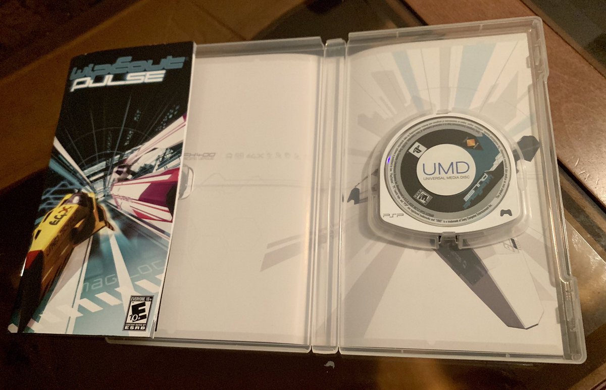 JoshuaMFrench's tweet photo. This #PSPWednesday I’ve got WipEout Pure and Pulse, both top-notch handheld entries in the anti-gravity racing series that premiered on the original PlayStation. Aside from multiplayer features, these releases also experimented w/ DLC and even custom skins shared via portal site. https://t.co/k1zOUoUTV1