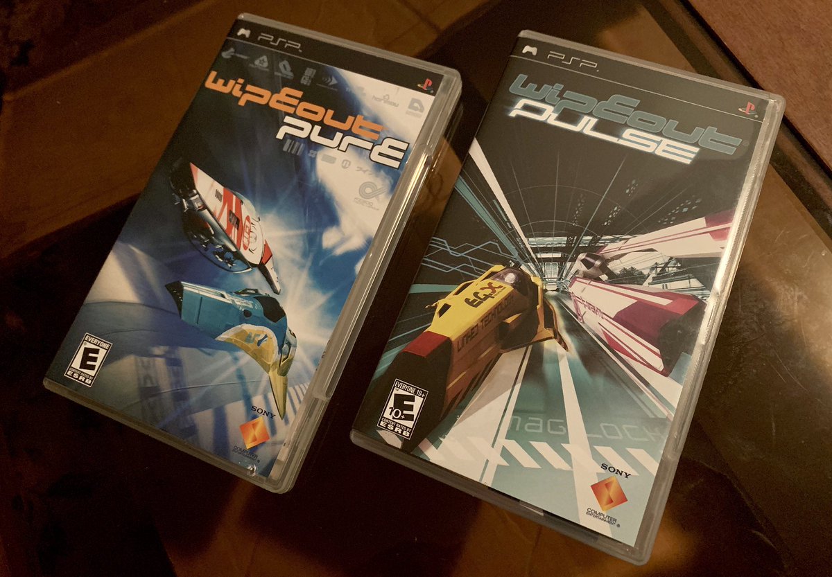 JoshuaMFrench's tweet photo. This #PSPWednesday I’ve got WipEout Pure and Pulse, both top-notch handheld entries in the anti-gravity racing series that premiered on the original PlayStation. Aside from multiplayer features, these releases also experimented w/ DLC and even custom skins shared via portal site. https://t.co/k1zOUoUTV1